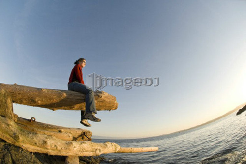 A woman enjoys the sunset on Victoria BC's waterfront