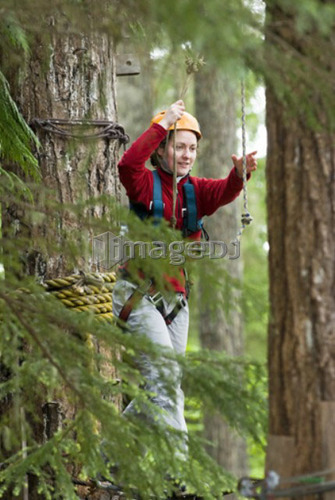 A woman works her way through a high ropes course at the Strathcona Park Lodge, BC