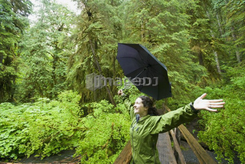 A woman enjoying the rainforest near Marymere Falls in Olympic National Park