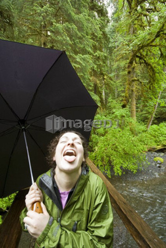 A woman enjoying the rainforest near Marymere Falls in Olympic National Park