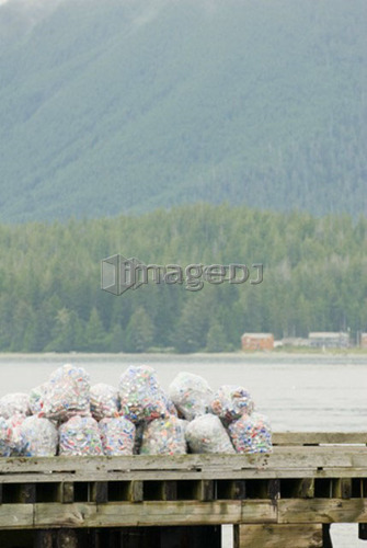 Bags of aluminum cans sit on the dock in Tofino, BC waiting to be recycled.
