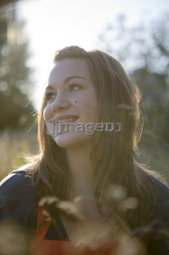 Portrait of female, 17, in tall grass, Vancouver, BC