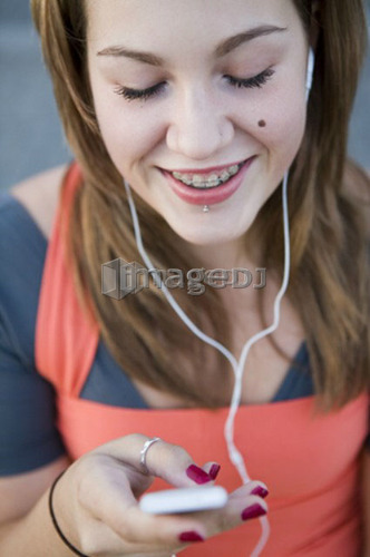 Female, 17, listening to ipod outdoors, Fraser River, Vancouver, BC