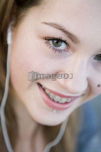 Female, 17, listening to ipod outdoors, Fraser River, Vancouver, BC