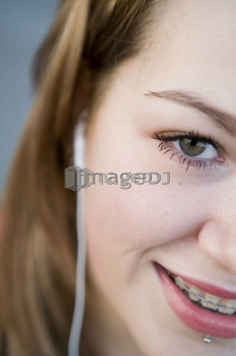 Female, 17, listening to ipod outdoors, Fraser River, Vancouver, BC