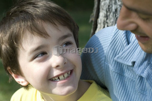 Six year old boy looks upward to father, Winnipeg, Canada