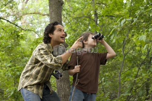 Young boy and father looking through binoculars, Assiniboine Park, Winnipeg, Canada