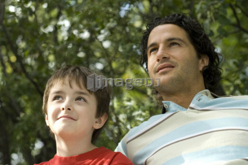 Six year old boy and father looking upward, Winnipeg, Canada