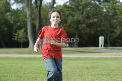 Six year old boy running toward camera, Assiniboine Park, Winnipeg, Canada