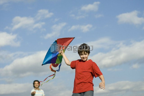 Six year old boy and father try to fly a kite, Assiniboine Park, Winnipeg, Canada