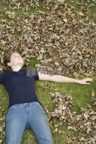 Teen girl making leaf angels