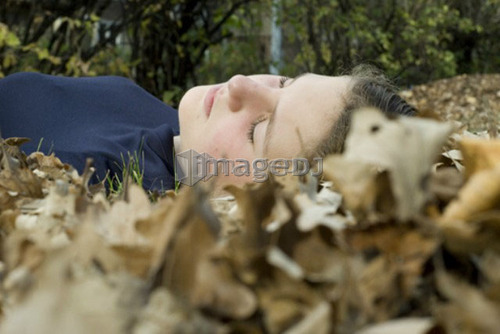 Girl lying in the leaves, Winnipeg, Canada