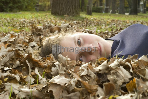 Girl lying in the leaves, Winnipeg, Canada