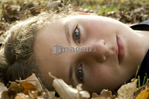 Girl lying in the leaves, Winnipeg, Canada