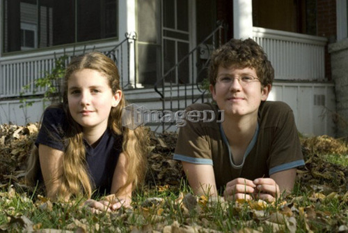 Teen brother and sister lying in leaves, Winnipeg, Canada