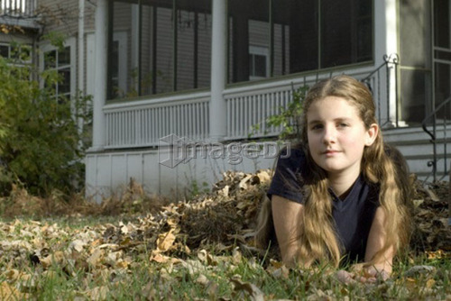 Girl lying in the leaves, Winnipeg, Canada