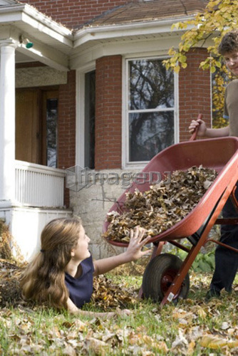Teen brother dumping leaves on sister, Winnipeg, Canada