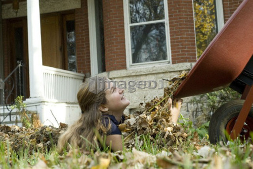 Teen girl getting leaves dumped on her, Winnipeg, Canada