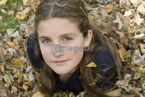Girl lying in leaves, Winnipeg, Canada
