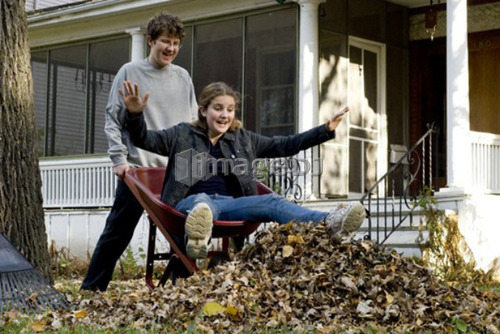 Brother dumping sister out of wheelbarrow, Winnipeg, Canada