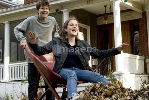 Brother dumping sister out of wheelbarrow, Winnipeg, Canada