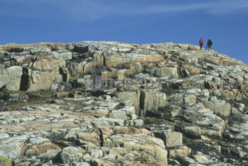 Hikers on rocky island, Ukkusiksalik National Park, Wager Bay, Nunavut, Canada