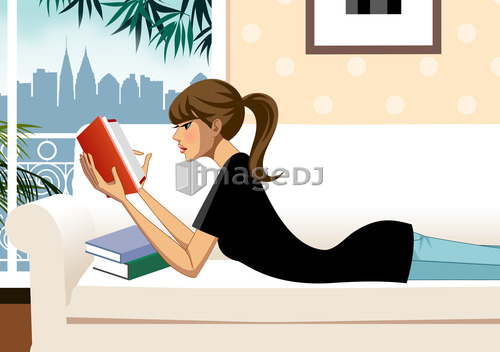 Woman lying on sofa reading book