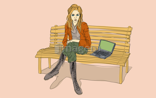 Young woman with laptop sitting on bench