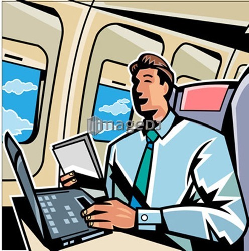 Businessman working on a laptop in an airplane